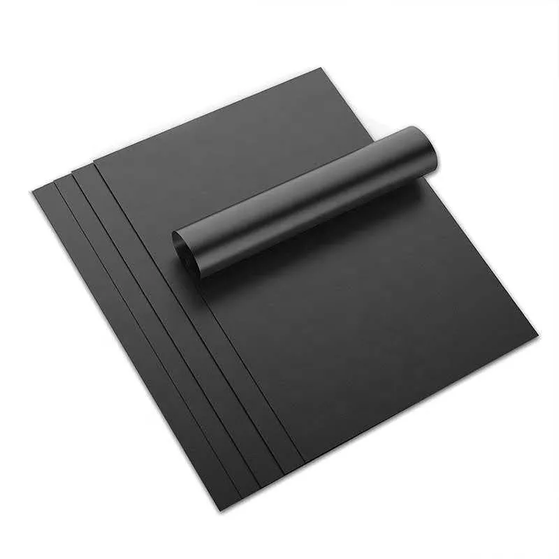 Black PTFE baking mat roll and flat sheet on clean background
