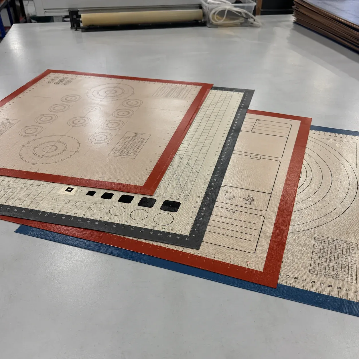 Custom black silicone-fiberglass functional mat with ruler scales and positioning targets