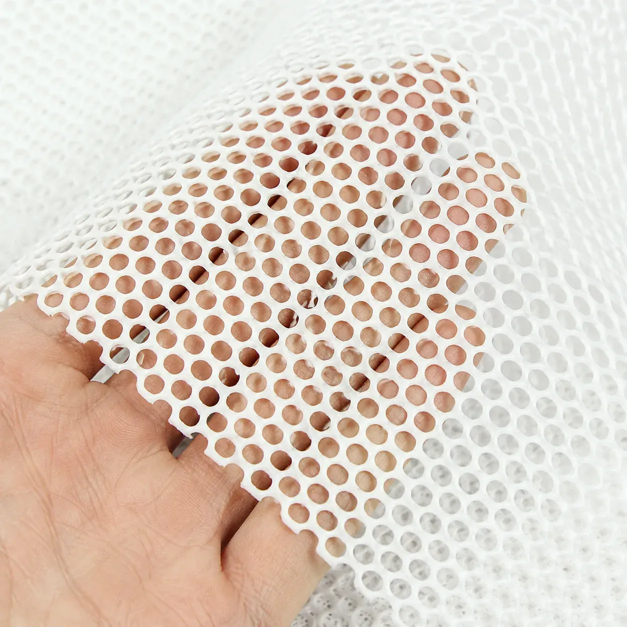 Close-up of the large-hole silicone mesh surface