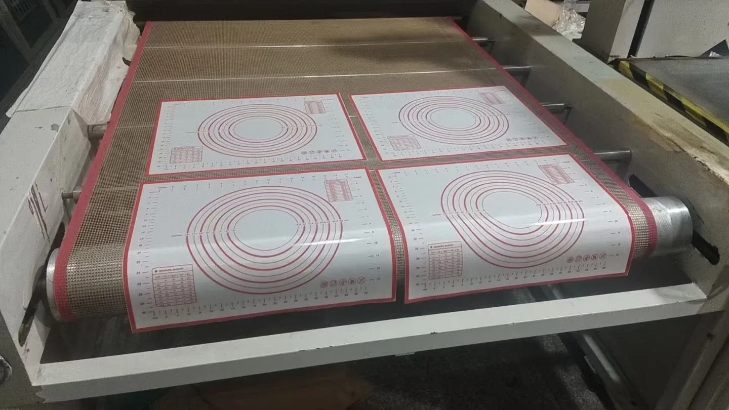 Printed pastry mat sheets with red measurement guides on production equipment